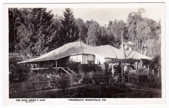 Shows a black and white postcard of the Crossways in Marysville in Victoria. On the reverse of the postcard is a space to write a message and an address and to place a postage stamp. The postcard is unused.