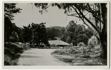 A black and white postcard of the Crossways Cabaret in Marysville in Victoria. On the reverse is a space to write a message and an address and to place a postage stamp. The postcard is unused.