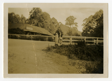 A black and white photograph of an unknown lady standing outside The Crossways in Marysville.