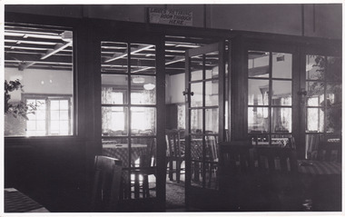 A black and white photograph of the view looking from the supper room into the dance room at the Crossways Cabaret in Marysville.