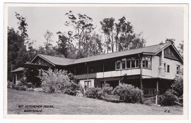 A black and white postcard of Mt. Kitchener House in Marysville that was produced by the Valentine Publishing Co Pty. Ltd. as a souvenir of Marysville. On the reverse of the postcard is a space to write a message and an address and to place a postcage stamp. The postcard is unused.