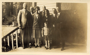 A digital copy of a black and white photograph of an unknown group of guests from Geelong standing on the verandah at Mount Kitchener House in Marysville in 1930.