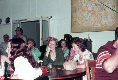 A digital copy of a colour photograph taken of a group of people having dinner at Mountain Lodge in 1974.