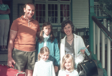 A digital copy of a colour photograph of a group of guests standing on the front verandah at Mountain Lodge in Marysville that was taken in 1974.