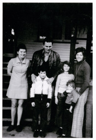 A black and white photograph of Hubert and Suzette Nassl standing with guests on the verandah at Mountain Lodge in 1974.