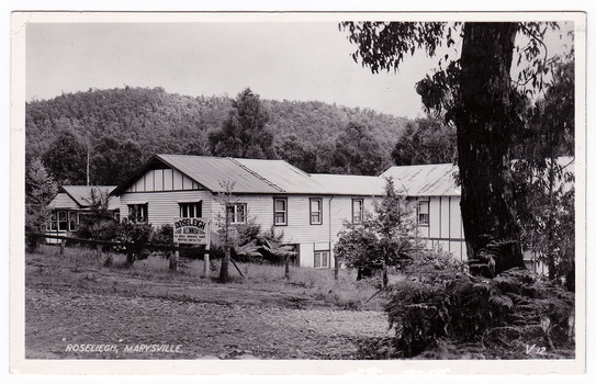 A black and white postcard of Roseleigh Guest House in Marysville that was produced by Valentine Publishing Co. Pty Ltd as a souvenir of Marysville. There is a hand written message on the reverse.