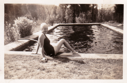 A black and white photograph of Nancy Duncan seated by the swimming pool at Roseleigh guest house in Marysville. The photograph was taken in about 1944.