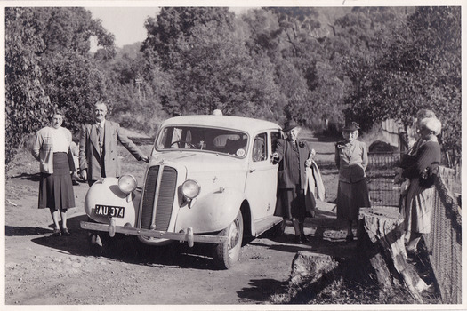 A black and white photograph of guests leaving Roseleigh in Marysville. The photograph was taken in April, 1949 by Roy Liebig. The photograph has been incorrectly labeled as "Healesville".