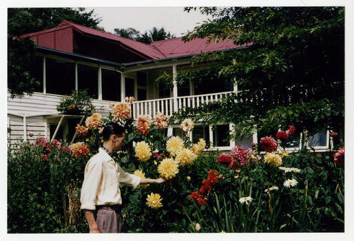 A colour photograph of an unknown lady in the gardens at The Cumberland guest house in Marysville.