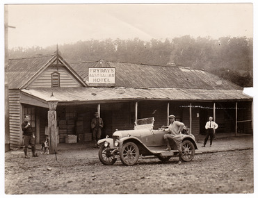 A black and white photograph of Fryday's Australian Hotel in Marysville. The hotel was originally built and opened by the Keppel Family in 1865 and named the Keppel's Australian Hotel. It was the first hotel to be opened in Marysville. In 1921 the licence to the Keppel's Australian Hotel was transferred to Emma Fryday and it was renamed the Fryday's Australian Hotel. The Keppel Family were among Marysville's earliest pioneering families. On the reverse is a stamp from Edwin G. Adamson Photography.