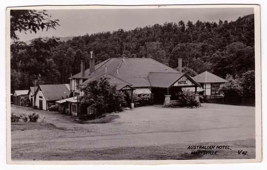A black and white postcard of the Australian Hotel in Marysville that was produced by The Valentine Publishing Co. Pty. Ltd. as a souvenir of Marysville. The hotel was originally built and opened by the Keppel Family in 1865. The Keppel's Australian Hotel was the first hotel to be opened in Marysville. The Keppel Family were among Marysville's earliest pioneering families. On the reverse is a hand written message.