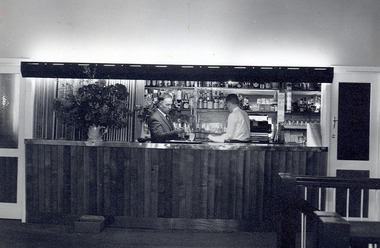 A digital copy of a black and white photograph of the bar at the Marysville Hotel Motel in Marysville. The original photograph was taken in 1962.