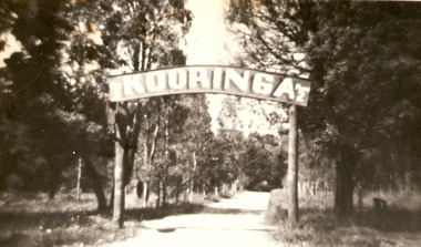 A copy of a black and white photograph of the 'Kooringa' sign which was over the original road in from the main street, Murchison Street, in Marysville. The original photograph was taken in the 1920s.