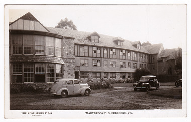 A black and white postcard of Marybrooke guest house in Sherbrooke. Marybrooke was part of the Mary Chain of guest houses built by Eric Dowdle during the Depression years. The postcard was produced by the Rose Stereograph Company as a souvenir of Sherbrooke. On the reverse of the postcard is a space to write a message and an address and to place a postage stamp. The postcard is unused.