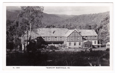 A black and white postcard from Marylyn Guest House in Marysville. Marylyn was a part of the Mary Chain of guest houses built by Eric Dowdle in the Depression years. The postcard was produced by the Rose Stereograph Company as a souvenir of Marysville. On the reverse is a hand-written message.