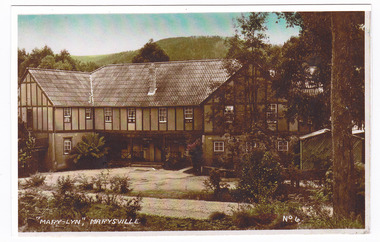 A colour photograph of a postcard from Mary-Lyn Guest House in Marysville. Mary-Lyn was a part of the Mary Chain of guest houses built by Eric Dowdle in the Depression years. The original postcard was produced by Valentine Publishing Co Pty. Ltd. as a souvenir of Marysville.