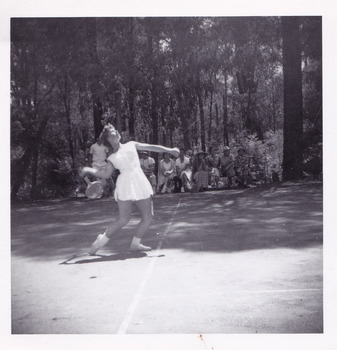 A black and white photograph that was taken at Mary-Lyn Guest House in Marysville. Mary-Lyn was a part of the Mary Chain of guest houses built by Eric Dowdle in the Depression years. The photograph is of a lady named Pat Weeden playing tennis at Mary-Lyn.