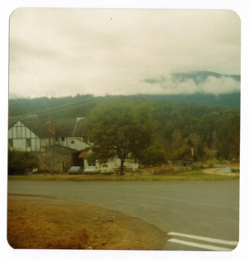A colour photograph of Mary-Lyn Guest House in Marysville. Mary-Lyn was a part of the Mary Chain of guest houses built by Eric Dowdle during the Depression years. The photograph was taken in 1979 and shows a view of the main building with the mountains in the background.