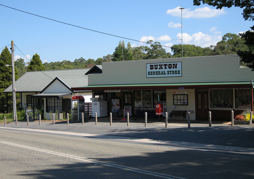 Shows the Buxton General Store in Victoria. Above the front of the store is a sign with the name of the store. There is a red Post Office box out the front. There is also a telephone paybox outside the store.