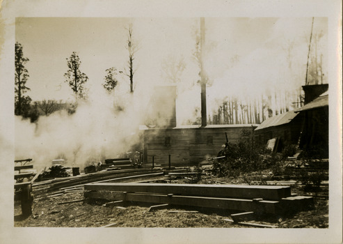 A black and white photograph of the Cambarville Sawmill near Marysville. Cambarville was established as a timber mill town in the 1940s. Timber mill owners A. Cameron and F.J. Barton named Cambarville. They established the mill to salvage timber from trees destroyed in the 1939 bushfires. Cambarville was impacted by the 2009 Black Saturday bushfires and any remaining structures were destroyed. The photograph was taken in October 1947.
