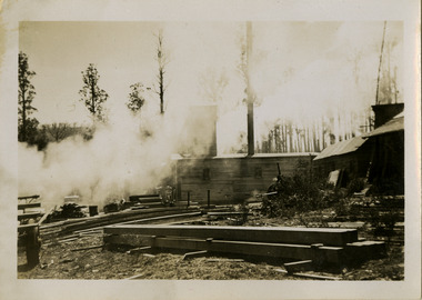 A black and white photograph of the Cambarville Sawmill near Marysville. Cambarville was established as a timber mill town in the 1940s. Timber mill owners A. Cameron and F.J. Barton named Cambarville. They established the mill to salvage timber from trees destroyed in the 1939 bushfires. Cambarville was impacted by the 2009 Black Saturday bushfires and any remaining structures were destroyed. The photograph was taken in October 1947.