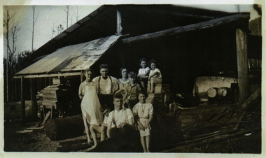 A copy of a black and white photograph of the Webb Family taken at the Andersons No. 1 Mill. George Webb worked at the mill. The original photograph was taken in the 1940s.