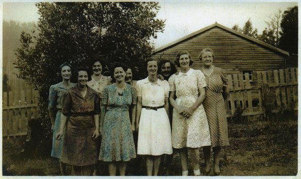 A copy of a colour tinted photograph of spouses of some of the Andersons No. 1 Sawmill workers. The original photograph was taken in 1943.