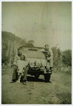A copy of a black and white photograph of Joe Newett and his children, Margaret and Charlie at Wilks Creek. The original photograph was taken in 1950.