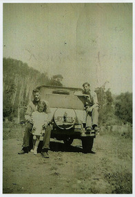 A copy of a black and white photograph of Joe Newett and his children, Margaret and Charlie at Wilks Creek. The original photograph was taken in 1950.