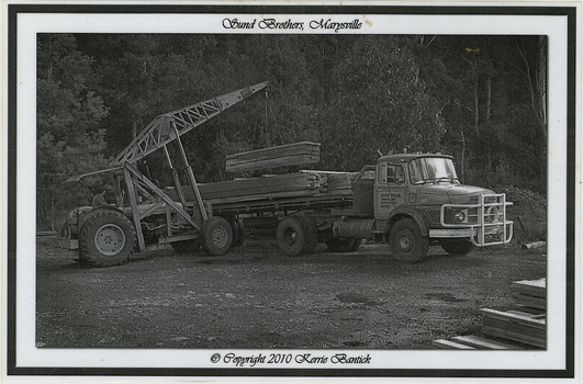 A black and white photograph of a Sunds Brothers truck being loaded with timber palings at the Sunds Bros Mill in Marysville. Sund's Sawmill (historically operated by Arthur & John Sund and often referenced locally as Sund Stenco) was a prominent mid-century timber mill located in Marysville, Victoria. It played a central role in the region's booming post-war logging era. 