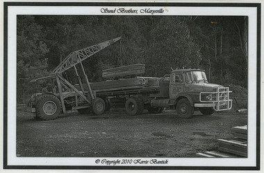 A black and white photograph of a Sunds Brothers truck being loaded with timber palings at the Sunds Bros Mill in Marysville. Sund's Sawmill (historically operated by Arthur & John Sund and often referenced locally as Sund Stenco) was a prominent mid-century timber mill located in Marysville, Victoria. It played a central role in the region's booming post-war logging era. 