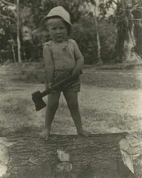 Two black and white photographs of Lloyd Gould in his younger years. In the photographs he is standing on a log weilding a tomohawk to chop the log.