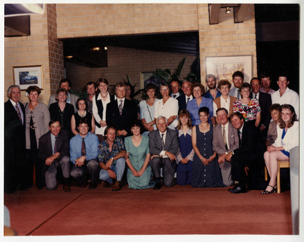 A colour group photograph taken of the staff at J.L. Gould Sawmills Pty. Ltd.