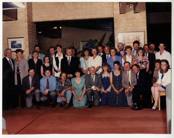 A colour group photograph taken of the staff at J.L. Gould Sawmills Pty. Ltd.
