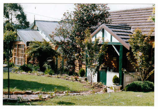 Shows a photograph of the front facade and garden at Green Arbor Galleries in Marysville.