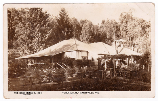 Shows a black and white postcard of the Crossways historic inn in Marysville in Victoria. On the reverse is a handwritten message.