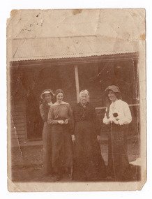 A digital copy of a black and white photograph of Bridget Kirwan and three unknown younger women.