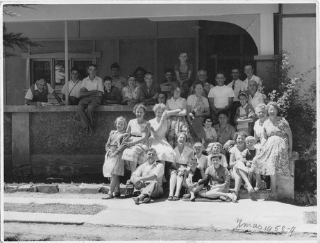 A digital copy of a black and white photograph of a group of people staying at Marysville House taken on Christmas Day in 1958. Marysville House was build in the late 1920s by Arthur Dickinson.