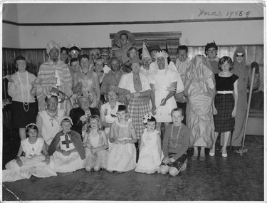 A digital copy of a black and white photograph of a group of people staying at Marysville House taken on Christmas Day in 1958. Marysville House was build in the late 1920s by Arthur Dickinson.