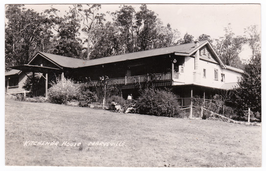 A black and white postcard of Kitchener House in Marysville. On the reverse of the postcard is a hand-written message.