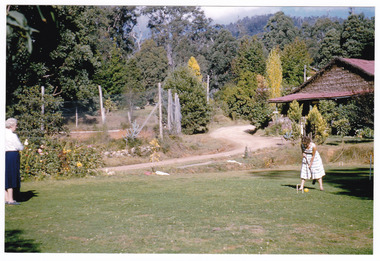 A colour photograph of a croquet game at Mount Kitchener House taken in April 1960.