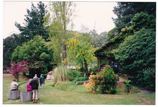 A colour photograph of an unknown group of people walking through the gardens at Mountain Lodge in Marysville. The photograph was taken in October, 1993.