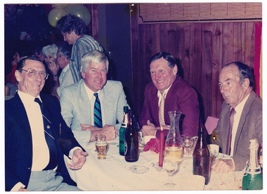 A colour photograph of two unknown men, Ken West and Jim Darmody sitting at a dinner table at The Marysville Hotel.
