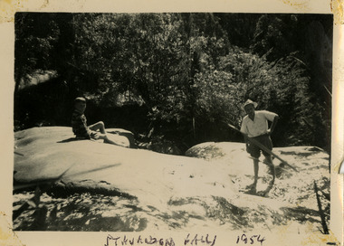 A black and white photograph of an unknown man and boy at Steavenson Falls in Marysville. The photograph was taken in 1954 during a stay at Roseleigh in Marysville.