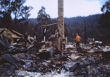 A copy of a colour photograph of the remains of Kerami Guest House after a fire in 1969 that destroyed the guest house.