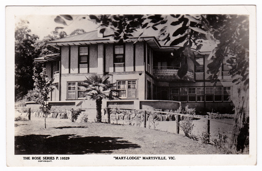 A black and white postcard from Mary-Lodge Guest House in Marysville. The postcard was produced by the Rose Stereograph Company as a souvenir of Marysville. On the reverse is a space to write a message and an address and to place a postage stamp. The postcard is unused.
