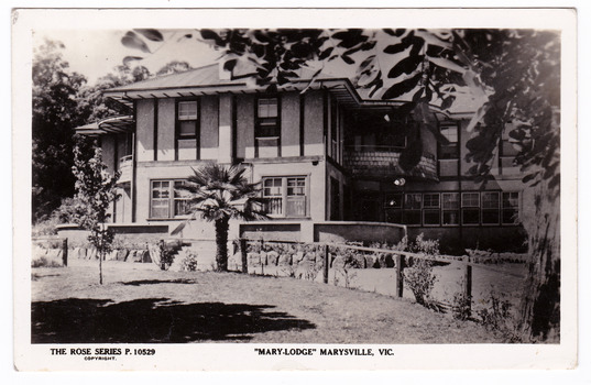 A black and white postcard from Mary-Lodge Guest House in Marysville. The postcard was produced by the Rose Stereograph Company as a souvenir of Marysville. On the reverse is a space to write a message and an address and to place a postage stamp. The postcard is unused.