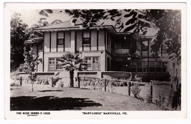 A black and white postcard from Mary-Lodge Guest House in Marysville. The postcard was produced by the Rose Stereograph Company as a souvenir of Marysville. On the reverse is a space to write a message and an address and to place a postage stamp. The postcard is unused.