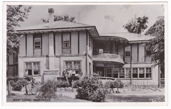 A black and white postcard from Mary Lodge Guest House in Marysville. The postcard was produced by Valentine Publishing Co. Pty. Ltd. as a souvenir of Marysville. On the reverse of the postcard is a hand written message.