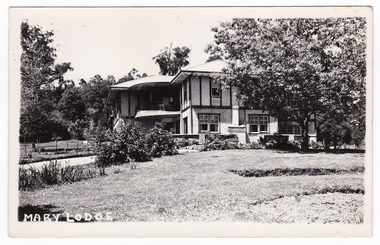 A black and white postcard from Mary Lodge Guest House in Marysville. The postcard was produced as a souvenir of Marysville. On the reverse is a space to write a message and an address and to place a postage stamp. The postcard is unused.